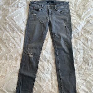 Gray Hudson distressed skinny jeans.